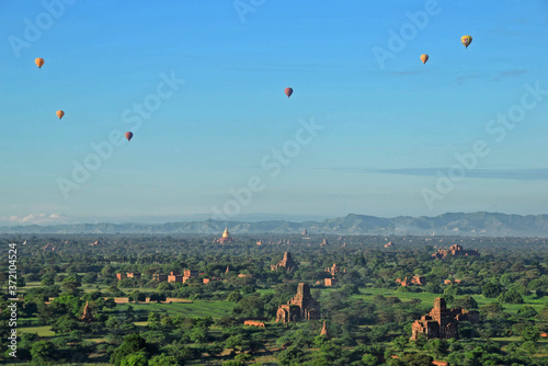 hot air balloon flying over the mountains in Bagan