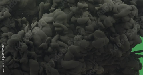 Blank ink blasting into a green screen 