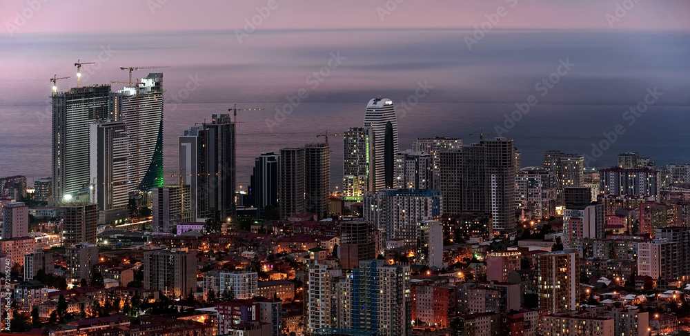 Naklejka premium Cloudy aerial Batumi cityscape in Georgia at evening