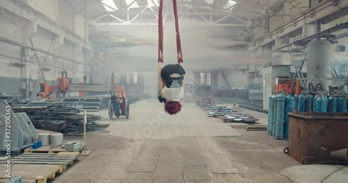 Redhead woman is doing aerial gymnastics and then walks off, gas mask, 4k photo