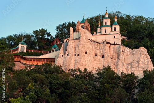 The cathedral on a chalk mountain of Sviatohirsk Lavra in Sviatohirsk, Ukraine at sunset photo