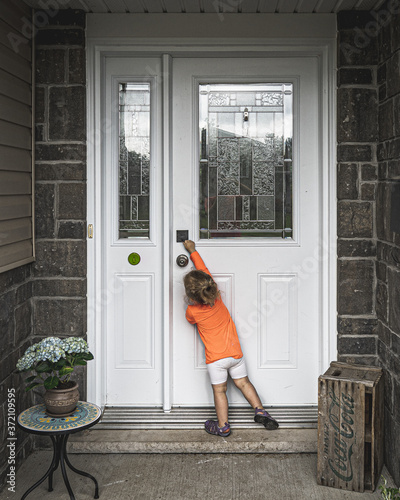 Girl playing with door lock.