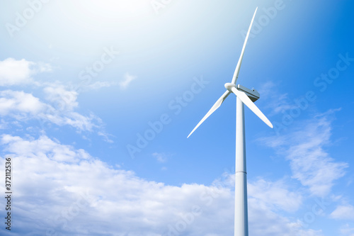 Alternative Energy Concepts. Windmill Outdoors Against Blue Sky