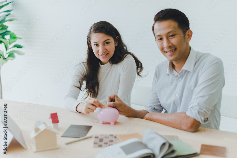 Asian couples, husbands and wives come together to design a house. To live together as a family in the future. Asian couples, husbands and wives come together to design a house. To live together as a family in the future.