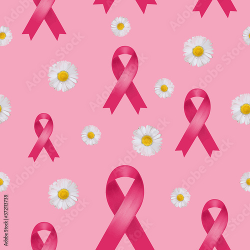 Breast cancer pink ribbon seamless pattern with daisies on pink background.