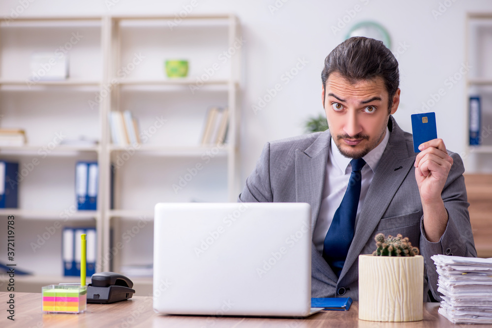 Young male employee working in the office Young male employee working in the office