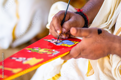 The Ceremonial bow, Onavillu. Artisan painting god's pictures on bow. It is made for annual rituals at Padmanabha swamy temple during Onam festival season. 
