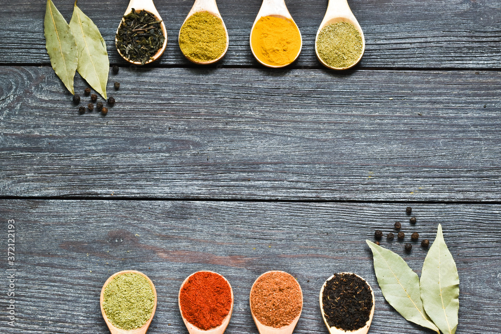 Herbs and spices in wooden spoons on a wooden background. Cooking, gardening or vegetarian concept. Copy space, flat lay,top view. Herbs and spices in wooden spoons on a wooden background. Cooking, gardening or vegetarian concept. Copy space, flat lay,top view.