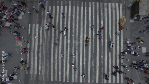 Vista aérea cenital para observar a una multitud pasar sobre el cruce peatonal más transitado de México. photo