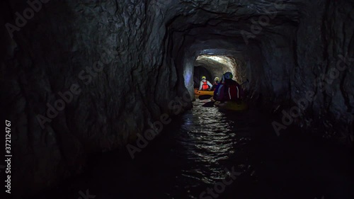Friends in two kayaks explore the mysterious underground mine tunnels photo