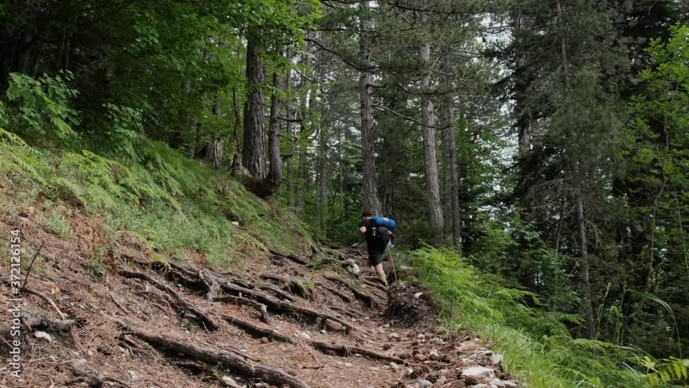 Male Hiker Climbing On The Rough Trail Of Mount Olympus In Greece - low angle shot Male Hiker Climbing On The Rough Trail Of Mount Olympus In Greece - low angle shot