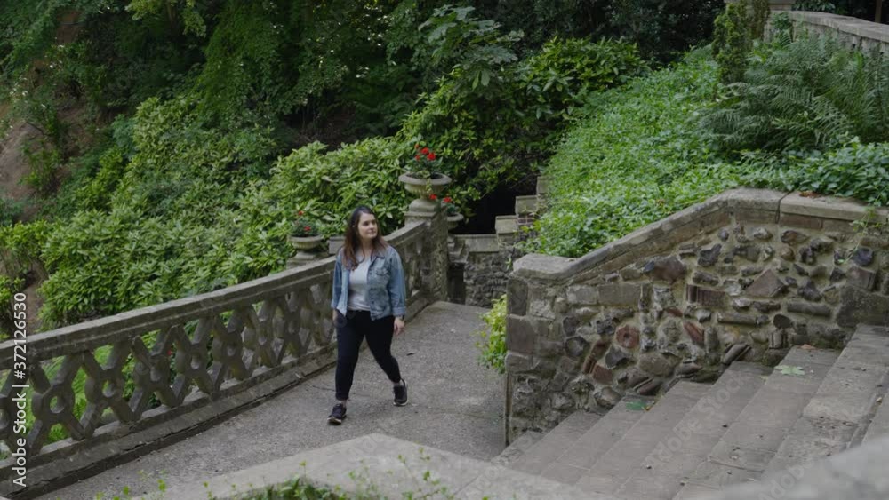 Woman visiting and exploring an incredible garden in Norwich, England
