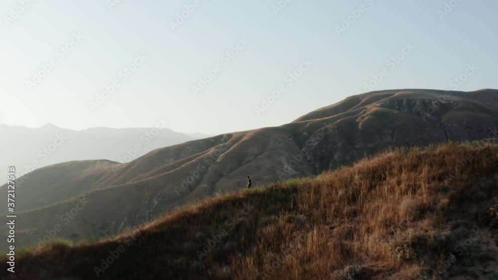 Spectacular close drone flight revealing hiker walking on Grimes Canyon ridge Spectacular close drone flight revealing hiker walking on Grimes Canyon ridge