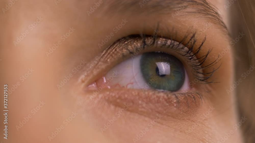 Woman open eyelid and pupil contracts, static extreme close up. Woman open eyelid and pupil contracts, static extreme close up.