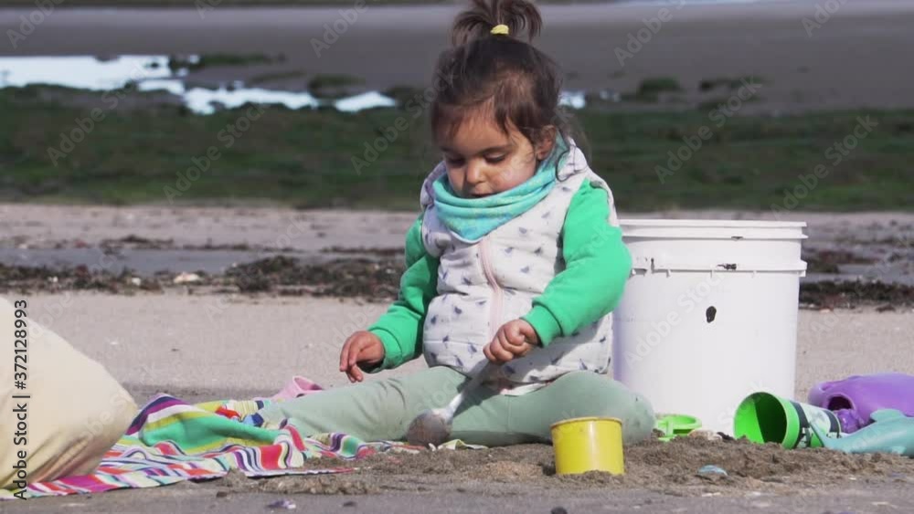 A Cute Girl Play with their toys on the beach, Slow Motion