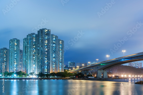 High rise residential building and bridge in Hong Kong city at night