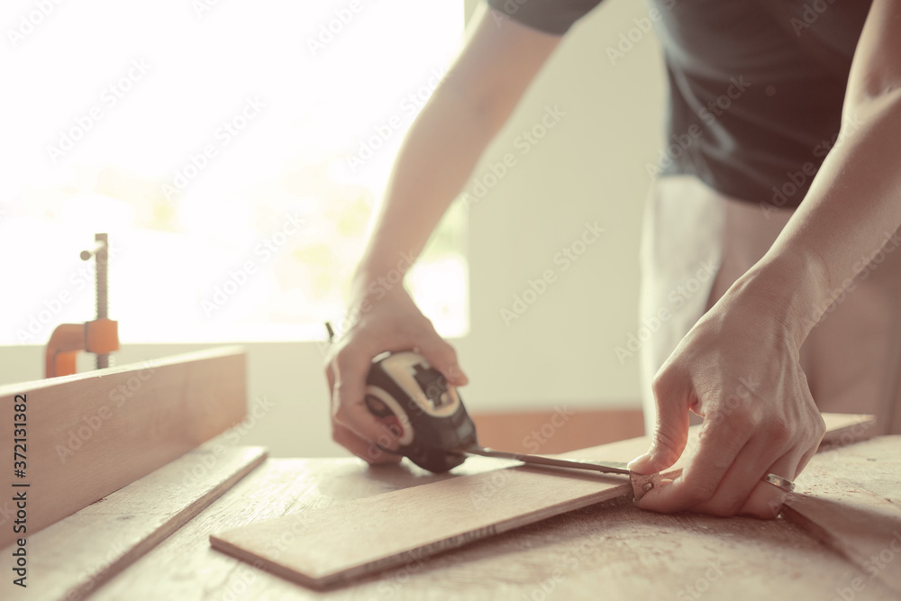 cutting wood for building,  carpenter, worker
 - obrazy, fototapety, plakaty 