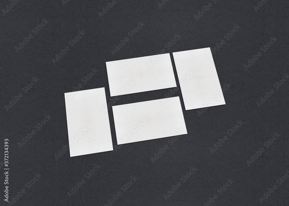 Blank white Business card mockup stacks on grey textured paper background. Blank white Business card mockup stacks on grey textured paper background.