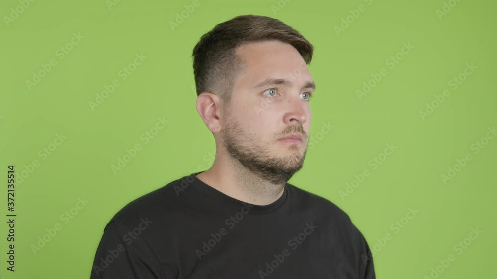 Man Removes Protective KN95 Face Mask While Looking Right of Camera on Green Screen Chroma Key Man Removes Protective KN95 Face Mask While Looking Right of Camera on Green Screen Chroma Key