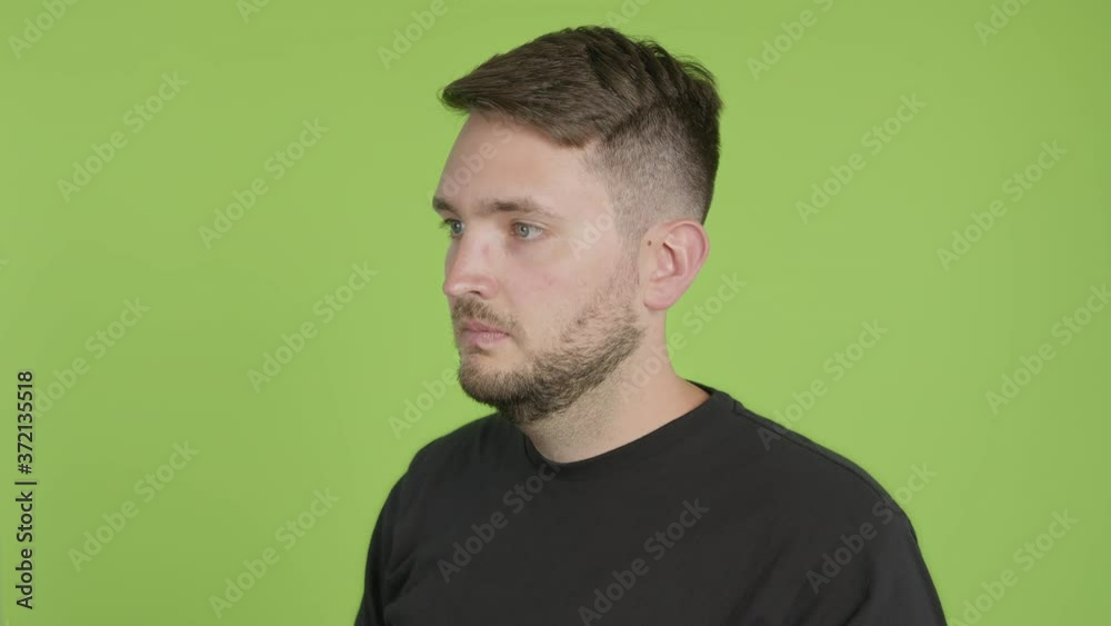 Man Removes Protective KN95 Face Mask While Looking Left of Camera on Green Screen Chroma Key Man Removes Protective KN95 Face Mask While Looking Left of Camera on Green Screen Chroma Key