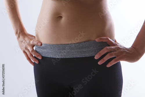 the result of sports exercises: a toned stomach close-up on a white background. Influence of diet