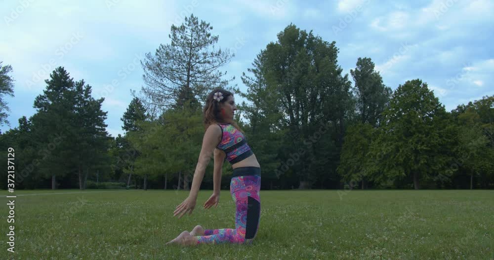 Young Attractive Female Doing Yoga on Grass, Making Camel Position and Namaste Sign, Slow Motion Young Attractive Female Doing Yoga on Grass, Making Camel Position and Namaste Sign, Slow Motion