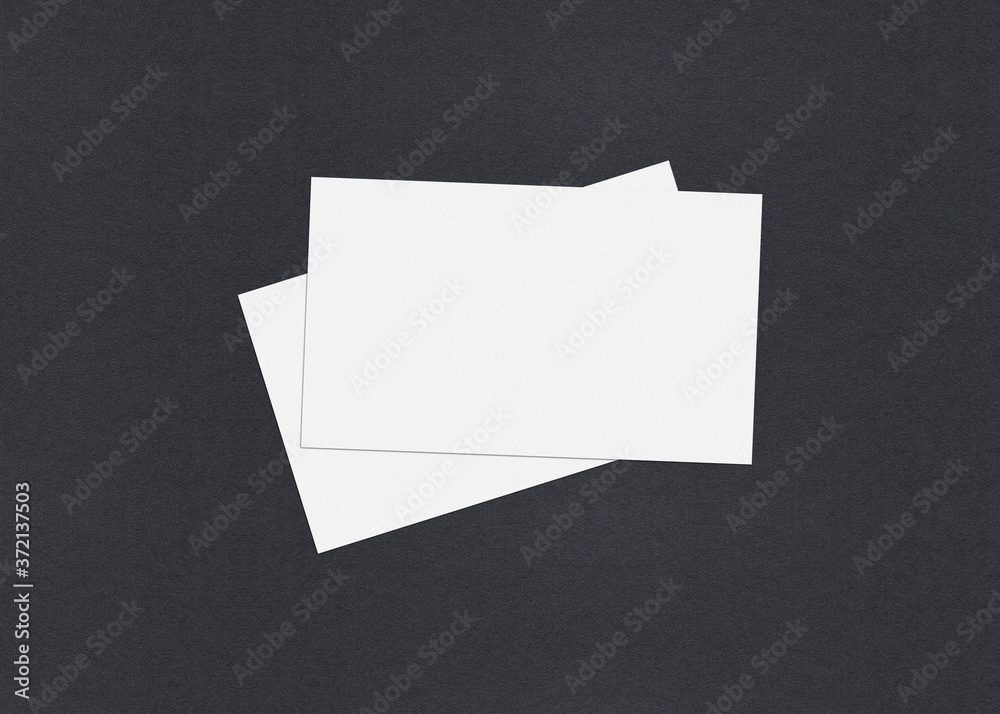 Blank white Business card mockup stacks on grey textured paper background. Blank white Business card mockup stacks on grey textured paper background.