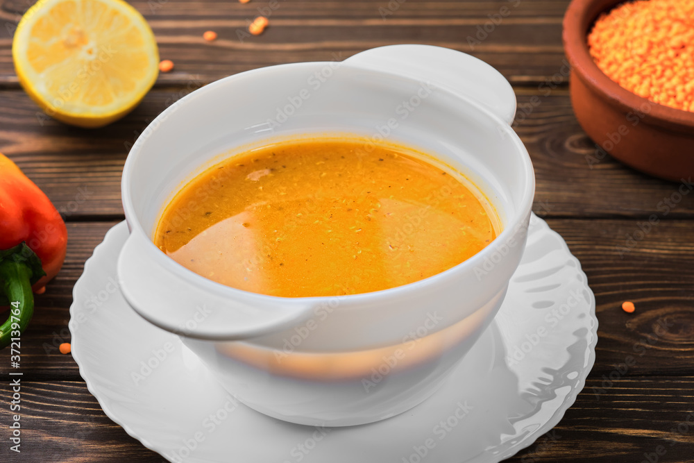 Homemade Turkish lentil soup (Merdzimek Chorbasy). Red lentil soup on a dark wooden table. Healthy and wholesome food. Close up Homemade Turkish lentil soup (Merdzimek Chorbasy). Red lentil soup on a dark wooden table. Healthy and wholesome food. Close up