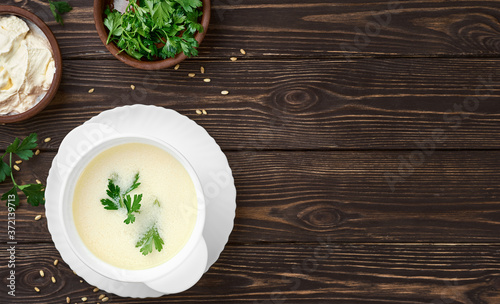Homemade Turkish yogurt soup (yayla soup), seasonal, summer soup, served hot or cold. Healthy wholesome food, the first starter dish. Top view, copy space