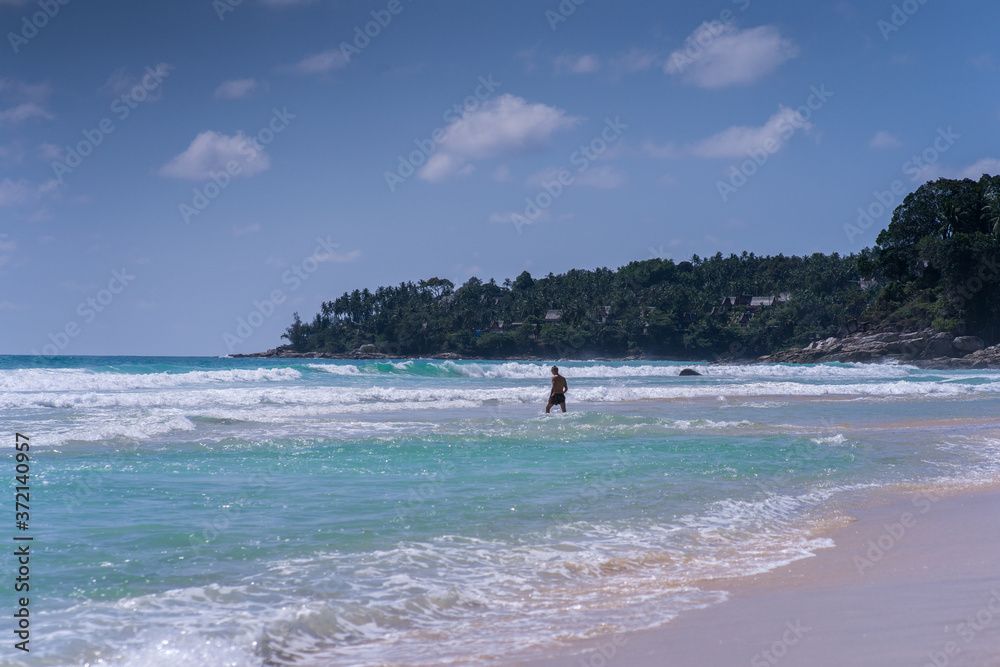man walking on beach, big waves, beautiful lagoon. Excellent for advertise man walking on beach, big waves, beautiful lagoon. Excellent for advertise