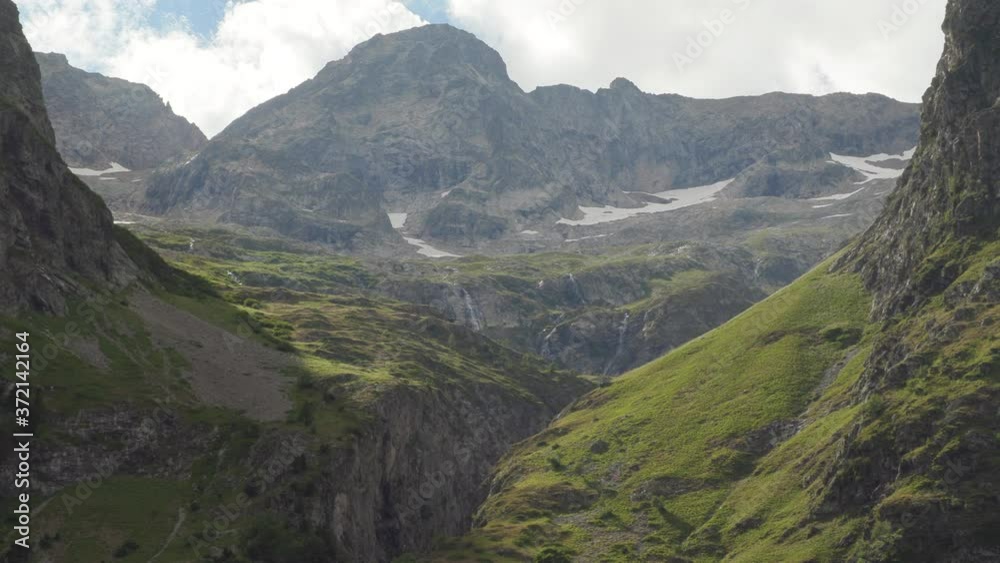 Extreme zoom out from the last sunny valley of the mountain back to the complete mountain range. 4K ProRes Extreme zoom out from the last sunny valley of the mountain back to the complete mountain range. 4K ProRes