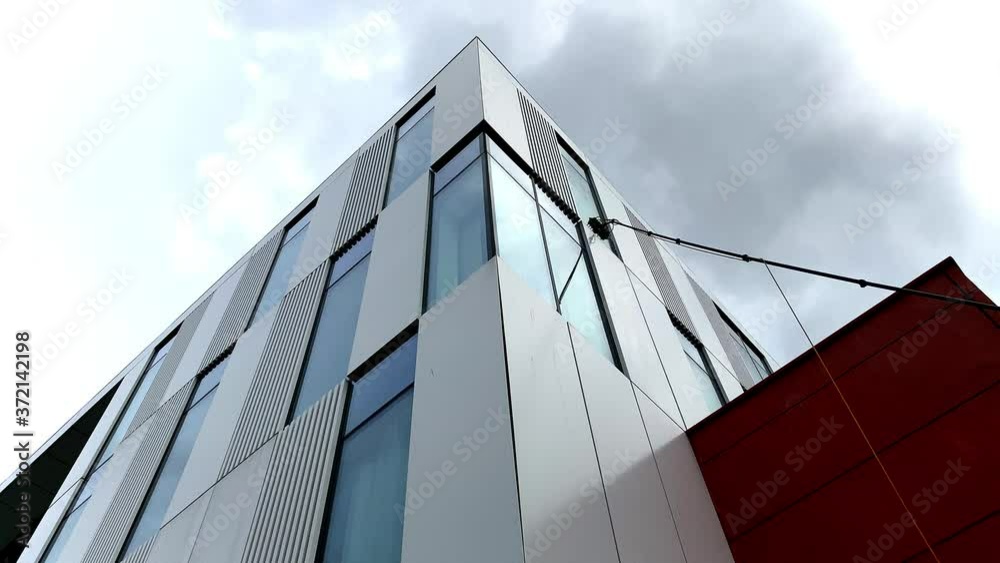 Low angle view commercial window cleaning using modern reach and wash techniques. Water fed pole. 