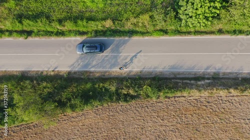 Cyclist casting a long shadow on the roads of Palau Sator Catalonia Spain. Birds eye aerial view. photo