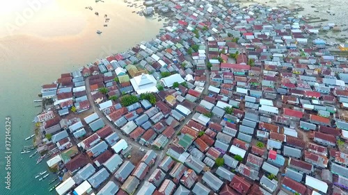 Wide aerial view over the fishing village of Bungin. Sumbawa Indonesia.  Beautiful sunset over the shacks and huts. photo