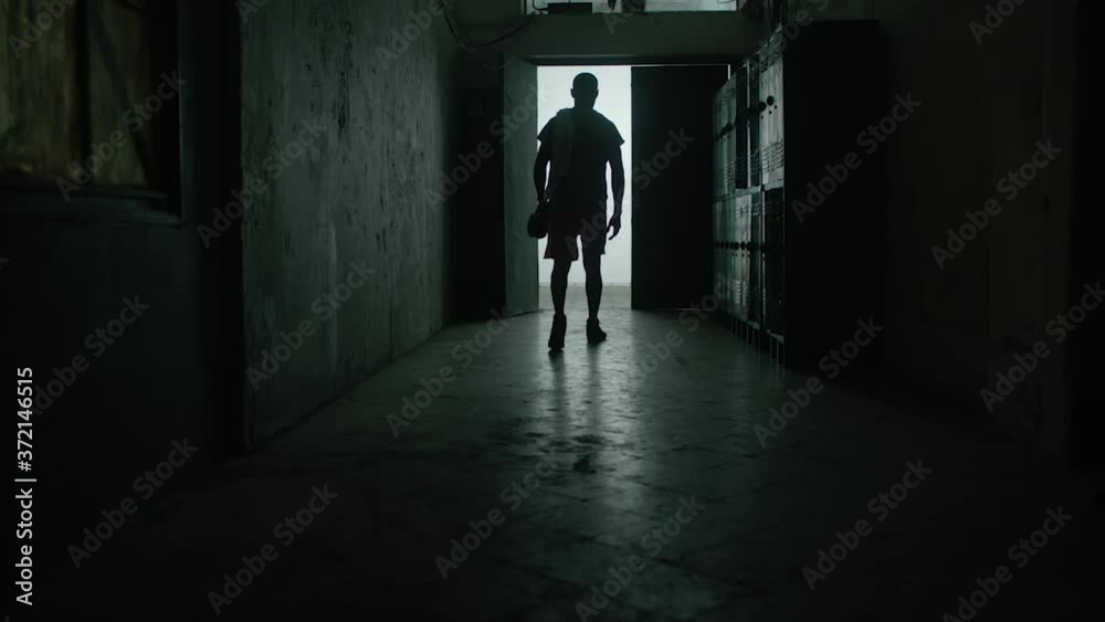 Back view young shirtless muscular Caucasian man hitting locker with his fist, tired and upset after failure in gym. Athletic weight lifter sportsman knocking on locker door overwhelmed after exercise Back view young shirtless muscular Caucasian man hitting locker with his fist, tired and upset after failure in gym. Athletic weight lifter sportsman knocking on locker door overwhelmed after exercise