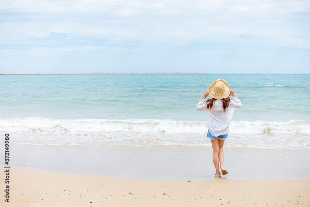 Happy young girl walking on the beach. Summer travel, vocation, holiday concept. Happy young girl walking on the beach. Summer travel, vocation, holiday concept.