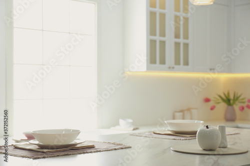 Elegant table setting in stylish kitchen interior