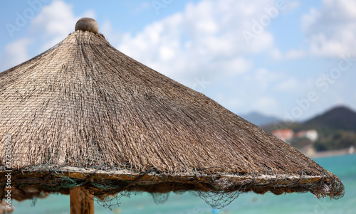 A deck chair made of palm branches on the beach