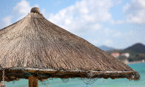 A deck chair made of palm branches on the beach © schankz