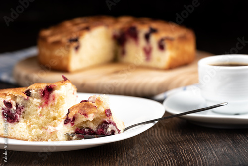Selective focus. Snack with cherry pie and black coffee.