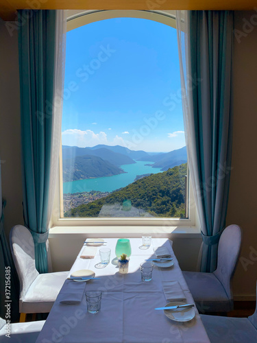 Window View over Alpine Lake Lugano and Mountain in Ticino, Switzerland.