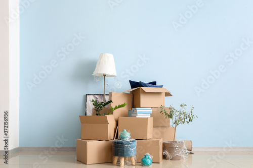 Cardboard boxes with belongings in new flat on moving day