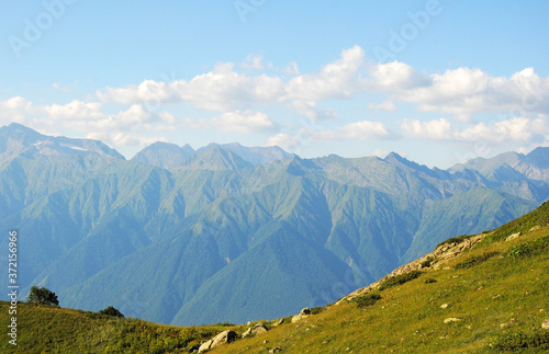 mountains with green grass and blue sky. georgeous nature