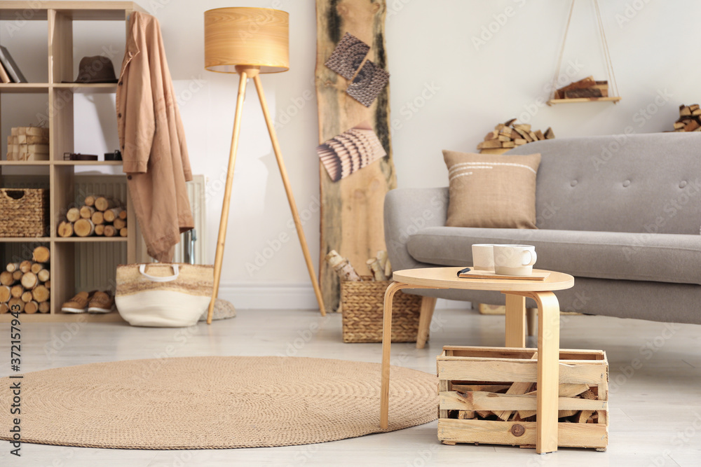 Stylish room interior with firewood as decorative element Stylish room interior with firewood as decorative element