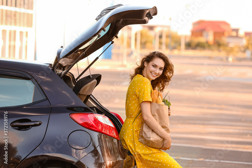 Young woman with grocery ba...