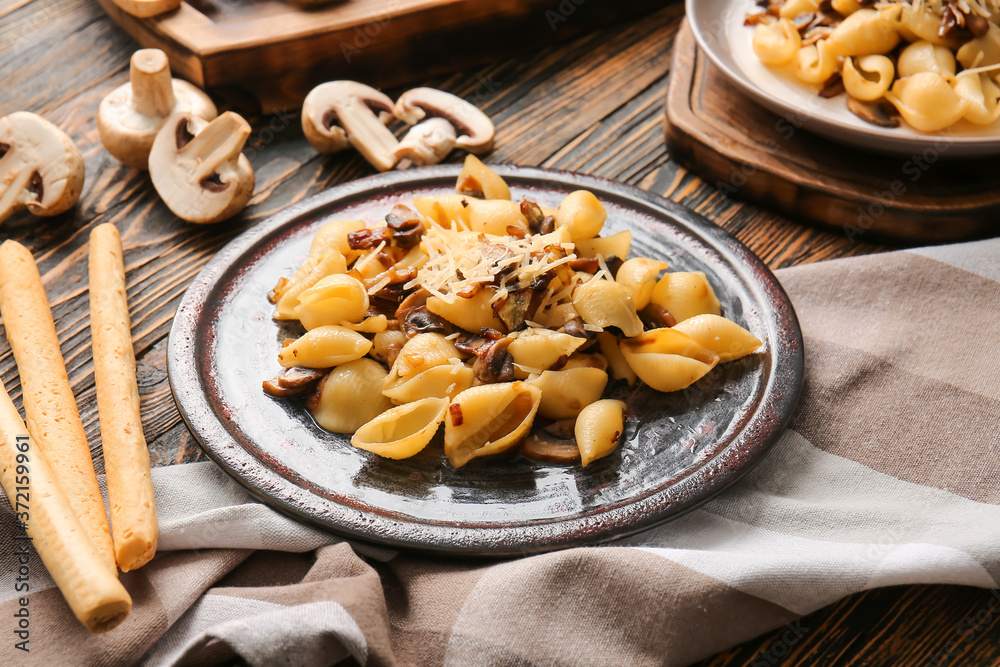 Plate with tasty conchiglie pasta on table Plate with tasty conchiglie pasta on table