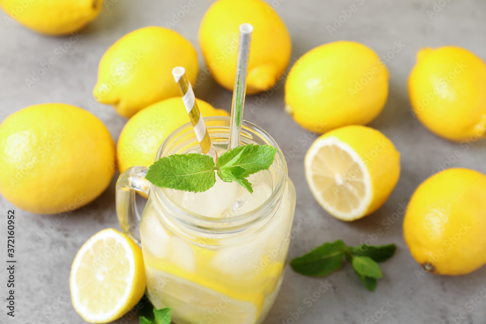 Natural freshly made lemonade and mint on light grey table, closeup. Summer refreshing drink Natural freshly made lemonade and mint on light grey table, closeup. Summer refreshing drink