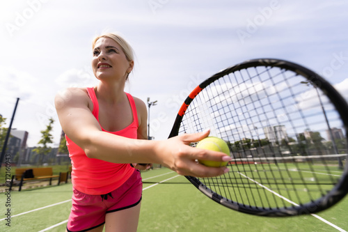 Pretty sportswoman with racquet at the tennis court. Healthy lifestyle © Angelov
