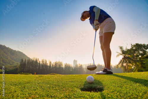 Close up Asian woman golfer playing golf at golf course ,Golfer hitting golf ball