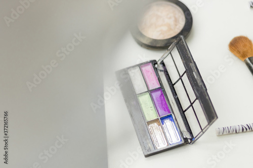 Photo of cosmetics top view on a white table. © Andrii